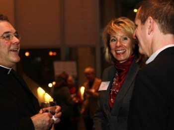 betsy-devos-and-priest_1484681039527_7704948_ver1-0